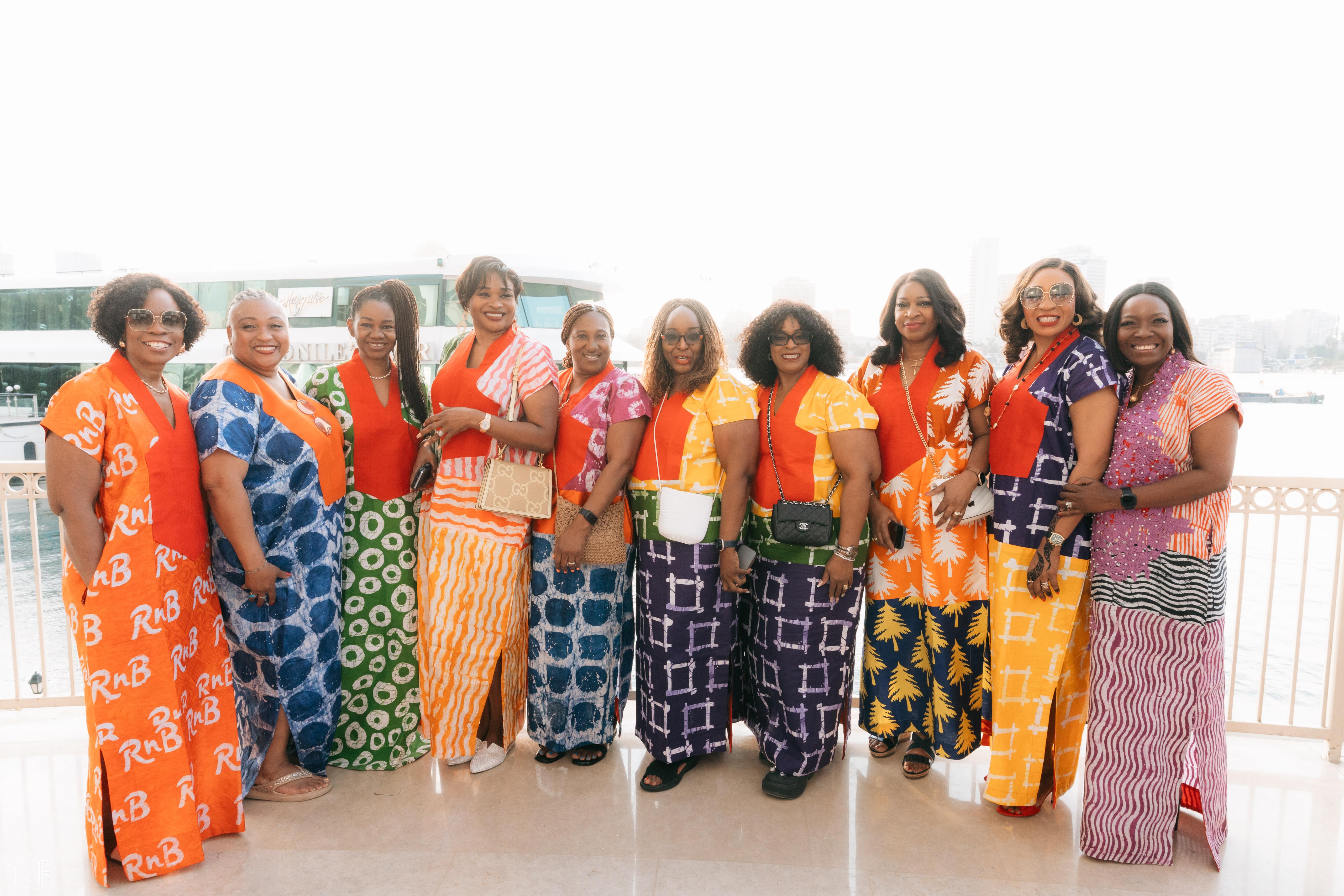 Group of women in colorful patterned bubus by the Nile