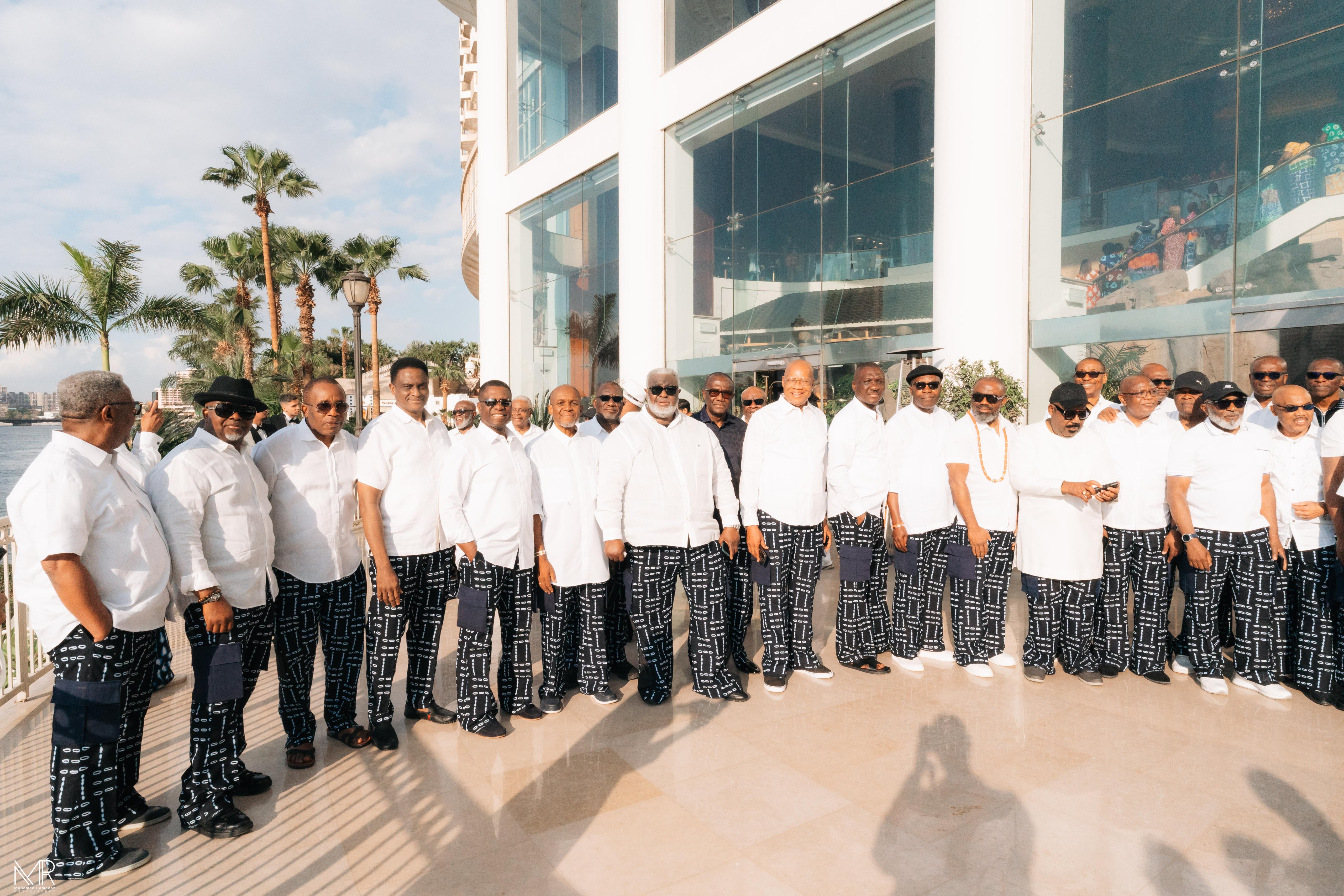 Group of men in white shirts and patterned trousers